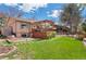 A sprawling lawn leads to a deck and beautifully landscaped backyard at 11545 Quivas Way, Westminster, CO 80234