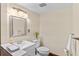Powder room featuring a modern sink, toilet, neutral wall color, and decorative plant at 11545 Quivas Way, Westminster, CO 80234