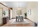 Bright dining room with a large window, a modern chandelier, and seating for six, creating a welcoming atmosphere at 11545 Quivas Way, Westminster, CO 80234
