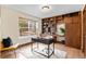 A cozy home office features custom built-in shelving, a modern desk, and ample natural light at 11545 Quivas Way, Westminster, CO 80234