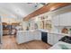 Well-lit kitchen with white cabinetry, quartz countertops, wooden beam, and stainless steel appliances at 11545 Quivas Way, Westminster, CO 80234