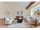 Inviting living room with vaulted ceilings, exposed beam, a neutral color palette, and lots of natural light at 11545 Quivas Way, Westminster, CO 80234