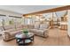 Spacious living room featuring a comfortable sectional sofa, wood beams, and hardwood flooring at 11545 Quivas Way, Westminster, CO 80234