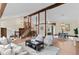 A bright living area features exposed wood beams, an open floor plan, and a cozy seating area at 11545 Quivas Way, Westminster, CO 80234