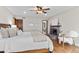 Comfortable main bedroom showcasing a brick fireplace, hardwood floors, and ample natural light at 11545 Quivas Way, Westminster, CO 80234