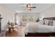 Main bedroom with a brick fireplace, hardwood floors, and access to the outside at 11545 Quivas Way, Westminster, CO 80234