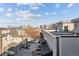 A cityscape view showcases modern architecture and neighborhood charm under a partly cloudy, bright sky at 2326 Eliot St # 2, Denver, CO 80211