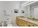 Well-lit bathroom featuring double sinks, granite countertops, and a large mirror at 3993 S Dillon Way # 104, Aurora, CO 80014