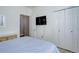 Bedroom featuring closet doors and a flat screen tv at 3993 S Dillon Way # 104, Aurora, CO 80014