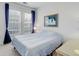 Bright bedroom featuring a comfortable bed, natural light from large windows, and a soothing artwork piece at 3993 S Dillon Way # 104, Aurora, CO 80014