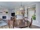 Open concept dining area with views of the living room, modern lighting, and stylish decor at 3993 S Dillon Way # 104, Aurora, CO 80014