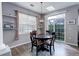 Cozy dining area with a round wooden table, stylish light fixture, and a view of the backyard at 3993 S Dillon Way # 104, Aurora, CO 80014