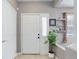 Welcoming entryway featuring a white door, tiled floors, and a view of the staircase at 3993 S Dillon Way # 104, Aurora, CO 80014
