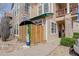 Charming condo featuring stone accents, wood siding, and a cozy, fenced patio area with privacy screen at 3993 S Dillon Way # 104, Aurora, CO 80014