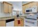 Efficient kitchen design with granite countertops and white appliances at 3993 S Dillon Way # 104, Aurora, CO 80014