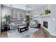 Comfortable living room features a plush sofa set, fireplace, and large windows at 3993 S Dillon Way # 104, Aurora, CO 80014