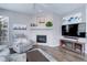 Comfortable living room with a decorative fireplace, modern TV setup, and a cozy gray recliner at 3993 S Dillon Way # 104, Aurora, CO 80014