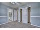 This carpeted bedroom features light blue walls and is connected to a bathroom and closet at 9445 E 106Th Pl, Commerce City, CO 80640