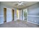 Bright bedroom with neutral carpet, a ceiling fan, and access to a bathroom and closet at 9445 E 106Th Pl, Commerce City, CO 80640