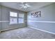Neutral bedroom offers a ceiling fan, large window, and fresh paint for a comfortable living space at 9445 E 106Th Pl, Commerce City, CO 80640