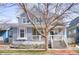 Charming two-story home featuring a welcoming front porch, well-maintained yard, and classic architectural details at 9445 E 106Th Pl, Commerce City, CO 80640