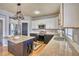 Modern kitchen with granite countertops, stainless steel appliances, and a stylish island with seating at 9445 E 106Th Pl, Commerce City, CO 80640