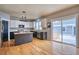 Well-equipped kitchen with modern appliances, a central island, and a seamless transition to the outdoor patio at 9445 E 106Th Pl, Commerce City, CO 80640
