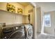 Laundry room with black and gray Samsung appliances and shelving at 9445 E 106Th Pl, Commerce City, CO 80640