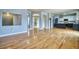 Bright, open-concept living area with hardwood floors seamlessly connecting to the kitchen and dining spaces at 9445 E 106Th Pl, Commerce City, CO 80640