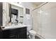 Clean bathroom with glass shower, modern vanity, and neutral color scheme at 17577 W 87Th Ave, Arvada, CO 80007