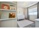 Bedroom features shiplap accent wall, stylish lighting, and shelving for books at 17577 W 87Th Ave, Arvada, CO 80007