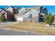 Exterior of a gray two-story house with stone accents and a three-car garage at 17577 W 87Th Ave, Arvada, CO 80007