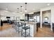 Spacious kitchen with large island, seating, pendant lights, and open floor plan at 17577 W 87Th Ave, Arvada, CO 80007