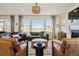 Cozy living room featuring hardwood floors, large windows, comfortable seating, and a decorative chandelier at 17577 W 87Th Ave, Arvada, CO 80007