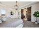 Main bedroom features sliding barn door to en suite bath, stylish lighting, and mountain views at 17577 W 87Th Ave, Arvada, CO 80007