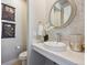 Chic powder room with vessel sink, decorative mirror, and stylish fixtures at 17577 W 87Th Ave, Arvada, CO 80007