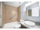 Bright bathroom featuring a tiled shower/tub, updated vanity, and modern fixtures at 4025 S Fundy Way, Aurora, CO 80013