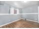 Cozy bedroom featuring hardwood floors, neutral paint, a window and ample natural light at 4025 S Fundy Way, Aurora, CO 80013