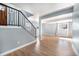 Bright living room with hardwood floors, fresh paint, and modern railing, adjacent to the entry at 4025 S Fundy Way, Aurora, CO 80013