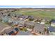 An aerial shot of houses near scenic open space with lush green fields at 16685 E 101St Ave, Commerce City, CO 80022