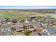 Aerial view of homes with tidy backyards and lawns, near open space at 16685 E 101St Ave, Commerce City, CO 80022