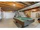 Unfinished basement featuring a pool table, offering potential for customization and recreational space in the home at 16685 E 101St Ave, Commerce City, CO 80022