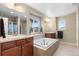 Luxurious bathroom with double sinks, soaking tub, and separate shower, creating a spa-like experience at 16685 E 101St Ave, Commerce City, CO 80022