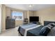 Spacious bedroom featuring a large window, a TV, neutral walls, and carpeted floors, creating a relaxing retreat at 16685 E 101St Ave, Commerce City, CO 80022