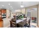Bright dining area with wooden table and chairs, open to kitchen and living room with access to patio at 16685 E 101St Ave, Commerce City, CO 80022