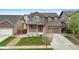 Inviting two-story home with a well-manicured lawn and a spacious two-car garage at 16685 E 101St Ave, Commerce City, CO 80022