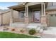 Charming front porch with stone accents, a cozy spot for relaxing and enjoying the neighborhood view at 16685 E 101St Ave, Commerce City, CO 80022