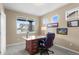 Bright home office with a large window, providing ample natural light and views of the neighborhood at 16685 E 101St Ave, Commerce City, CO 80022