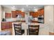 Spacious kitchen features stainless steel appliances, granite countertops, and a breakfast bar at 16685 E 101St Ave, Commerce City, CO 80022