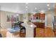 Open kitchen with stainless steel appliances, a breakfast bar, and a dining area at 16685 E 101St Ave, Commerce City, CO 80022